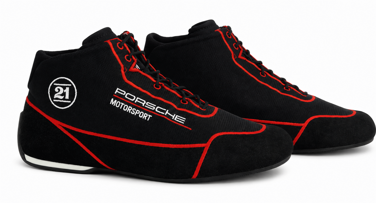 Black Porsche Motorsport racing shoes with red piping trim and Stand 21 logo accents, showcasing professional low-top driving sneakers designed for track day performance and optimal pedal grip. Black Porsche Motorsport racing shoes with red piping trim and Stand 21 logo accents, showcasing professional low-top driving sneakers designed for track day performance and optimal pedal grip.