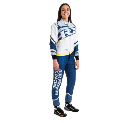 Female driver smiling while wearing a white and royal blue HRX Fuji Karting Suit featuring the brand logo on the chest and the slogan "Our Passion Is Racing" printed down the right pant leg.