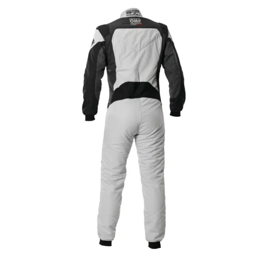 Front view of a white and silver OMP First Evo Suit with black sleeves, black shoulder pads, and subtle red "First Evo" branding text embroidered on the right thigh.