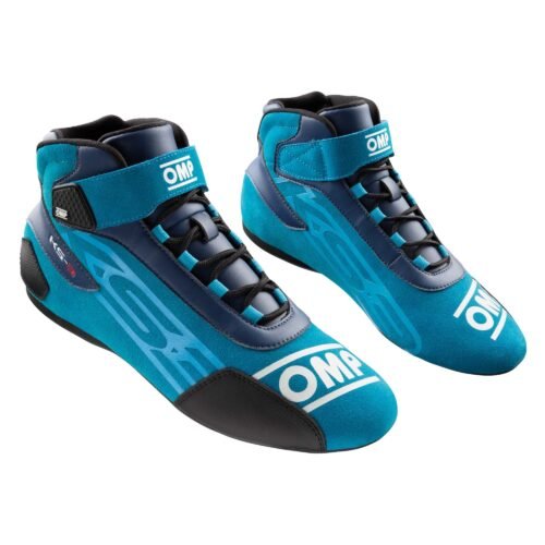 A pair of cyan blue and dark blue high-top OMP karting shoes with black laces, ankle straps, and branding on the toe and heel. A pair of cyan blue and dark blue high-top OMP karting shoes with black laces, ankle straps, and branding on the toe and heel.